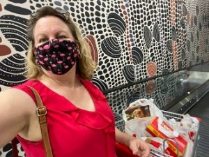 woman grocery shopping wearing a mask during Covid pandemic in December 2021