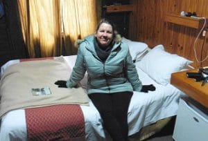 woman wearing warm clothing in cabin