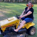 woman on a ride on mower